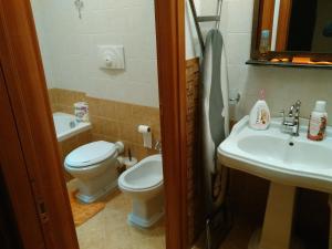 a bathroom with a toilet and a sink at Casa Poeta in Trapani