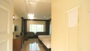 a hotel room with a bed and a living room at Wang Valley Resort in Pantai Cenang +47 photos