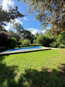 a large blue swimming pool in a park at Quinta El Arrayan in Tandil