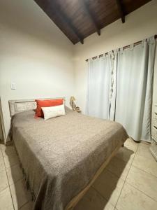 a bedroom with a large bed in a room at Quinta El Arrayan in Tandil