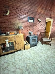 a patio with a brick wall and a stove at Quinta El Arrayan in Tandil