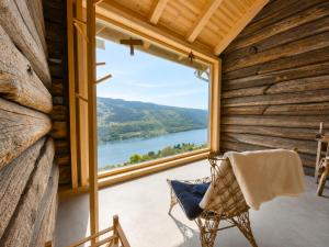 a room with a chair and a large window at Architect designed sleeping box in barn in Nos