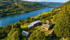 an aerial view of a house on a hill next to a lake at Architect designed sleeping box in barn in Nos +13 photos