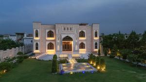 a large mansion with a fountain in the yard at Hamzas production in Islamabad +15 photos