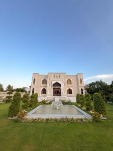 a building with a fountain in the middle of a yard at Hamzas production in Islamabad