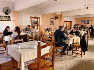 a group of people sitting at tables in a restaurant at Hotel Gran Lucerna in Valle Hermoso