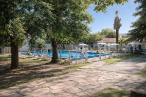 a pool at a resort with people swimming at Hotel Gran Lucerna in Valle Hermoso