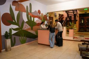 a group of people standing at a counter in a store at Hotel Gran Lucerna in Valle Hermoso
