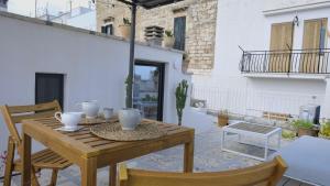 a wooden table and chairs on a patio at Casa Fidelia in Ceglie Messapica