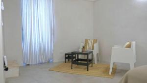 a living room with a table and a chair at Casa Fidelia in Ceglie Messapica