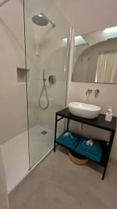 a bathroom with a sink and a shower at Casa Fidelia in Ceglie Messapica