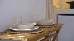 two bowls sitting on top of a wooden table at Casa Fidelia in Ceglie Messapica +1 photo