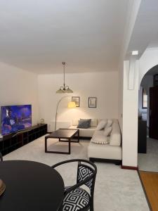 a living room with a couch and a table at Apartmán Ela in Komárno