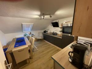 a kitchen with a table and a counter top at Ferienwohnungen Mews in Immenstadt im Allgäu