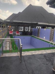 a swimming pool in the backyard of a house at Villa Liga Hotels Concerpts in Erunmu