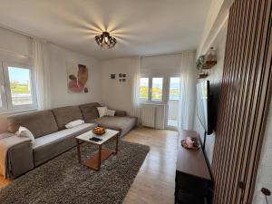 a living room with a couch and a tv at Dalmatia Nin Apartment with Private Jacuzzi in Nin
