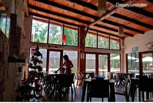 a woman sitting at a table in a restaurant with a christmas tree at Pamayu Mar de Cobo in Mar de Cobo +11 photos