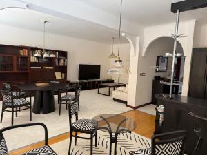 a living room with a black table and chairs at Apartmán Ela in Komárno
