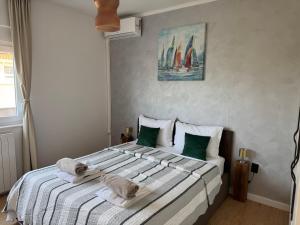a bedroom with a large bed with towels on it at Dalmatia Nin Apartment with Private Jacuzzi in Nin