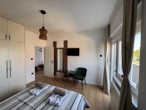 a bedroom with two beds and a desk at Dalmatia Nin Apartment with Private Jacuzzi in Nin