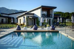 a swimming pool in front of a house at Maria village resort in Pavel Banya