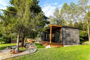a modern house in a garden with trees at Horizont Hillside Mályinka in Mályinka +14 photos