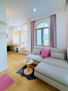 a living room with a couch and a table at Kharin guesthouse in Nakhon Phanom