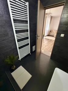 a bathroom with a toilet and a sink and a mirror at 4You in Cristuru Secuiesc