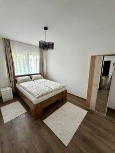 a bedroom with a bed and a window at 4You in Cristuru Secuiesc