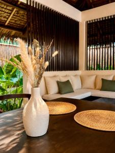 a white vase sitting on top of a table at Nayma Villas in General Luna +9 photos