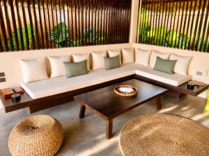 a living room with a couch and a table at Nayma Villas in General Luna