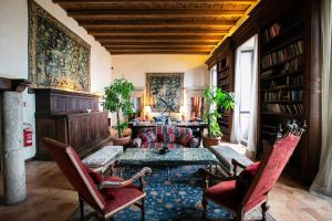 a living room with a couch and a table and chairs at La Posta Vecchia Hotel in Ladispoli