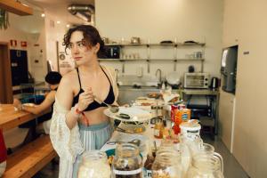 a woman standing in a kitchen preparing food at Lisbon Destination in Lisbon