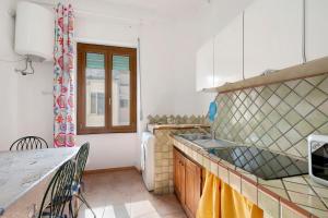 a kitchen with a sink and a counter top at Casa Silvia trilo calagavetta in La Maddalena