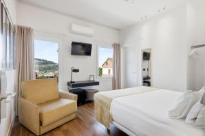 a hotel room with a bed and a chair at Pardavila 57 Slow Hotel in Marín +69 photos