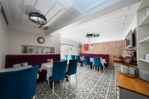 a restaurant with blue chairs and a table at Ersari Hotel in Istanbul