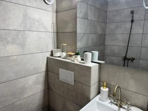 a bathroom with a sink and a shower at La Căsuță Rudeni in Rudeni +23 photos