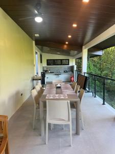 a table and chairs on a patio with a kitchen at The Villa at Mertolas in Alitagtag