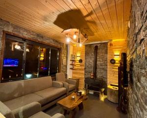 a living room with a couch and a table at YAYLAMİSUN SUITE HOTEL Luxury Nature Stay Çamlıhemşin in Çamlıhemşin