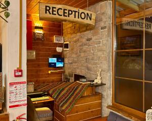 a room with a bed and a sign that reads reception at YAYLAMİSUN SUITE HOTEL Luxury Nature Stay Çamlıhemşin in Çamlıhemşin