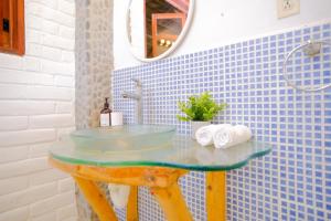 a blue tiled bathroom with a sink and a mirror at Las Golondrinas KM59 in Taquillo +94 photos