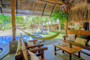 a room with a hammock and a swimming pool at Las Golondrinas KM59 in Taquillo