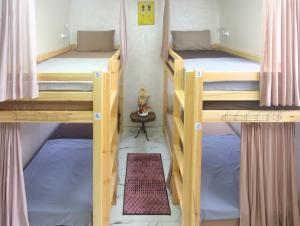 a room with three bunk beds in a room at Rooftop Hostel Dakhla in Dakhla