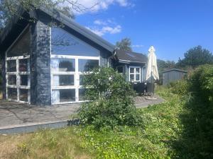 a house with white windows on the side of it at Herning, Sunds Lake Beautiful View & Spa 105 m2 in Sunds