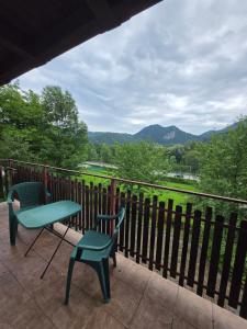 a table and two chairs on a balcony with a view at Willa Zwinka in Szczawnica