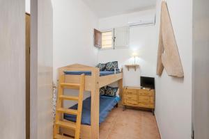 a small room with a bunk bed and a ladder at Casa Silvia trilo calagavetta in La Maddalena +5 photos