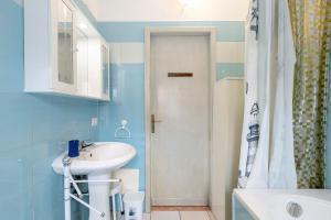 a bathroom with a white sink and a shower at Casa Silvia trilo calagavetta in La Maddalena