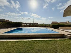 a swimming pool in the middle of a yard at شاليه بقرية الفيروز in Qaryat Shurūq