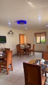 a dining room with tables and chairs and a blue ceiling at NBTE Hotels in Kaduna