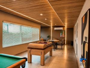 a room with a pool table and ping pong tables at Hotel Vivenda dos Corais in Porto De Galinhas +64 photos
